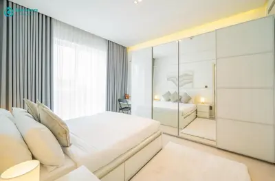 a bedroom with a bed and a glass wall at Blue Breeze - Modern Apt with Partial Marina Views & Balcony in Dubai