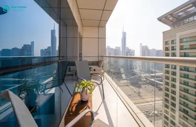a balcony with chairs and a view of the city at Blue Breeze - Modern Apt with Partial Marina Views & Balcony in Dubai