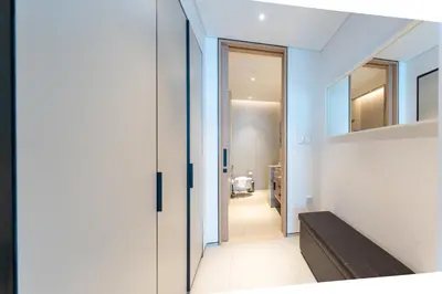 a hallway of a house with a door leading to a bathroom at Luxury 2 Bedroom Apartment with Breathtaking Dubai in Dubai