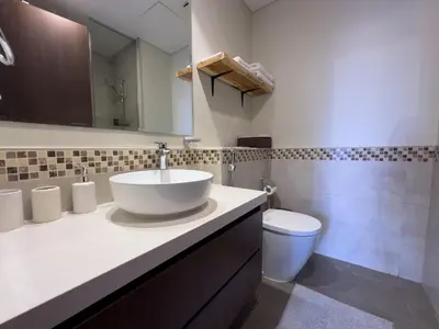 a bathroom with a sink and a toilet at japanDXB Burj Khalifa view - 4min Dubai Mall in Dubai
