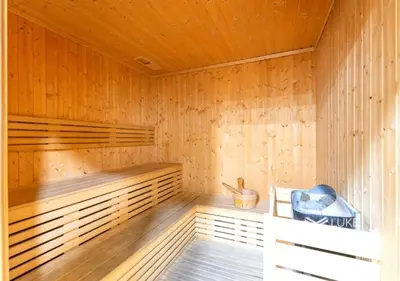 a wooden sauna with a bench and a basket in it at japanDXB Burj Khalifa view - 4min Dubai Mall in Dubai