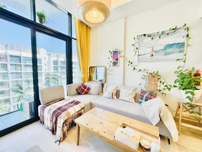 a living room with a couch and a table at Chic 1-BR in Azizi Riviera-Your Perfect Stay ! in Dubai