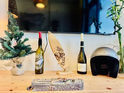 a table with three bottles of wine and a surfboard at Chic 1-BR in Azizi Riviera-Your Perfect Stay ! in Dubai