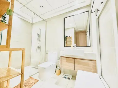 a bathroom with a toilet and a sink and a mirror at Chic 1-BR in Azizi Riviera-Your Perfect Stay ! in Dubai