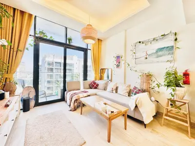 a living room with a couch and a table at Chic 1-BR in Azizi Riviera-Your Perfect Stay ! in Dubai