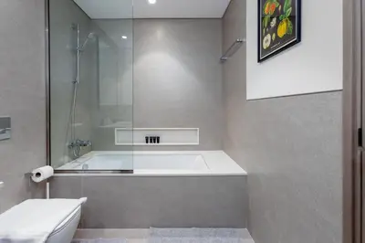 a bathroom with a tub and a glass shower at Near Burj Khalifa - 1BR Apartment in Grande Residence, Downtown - Allsopp & Allsopp in Dubai