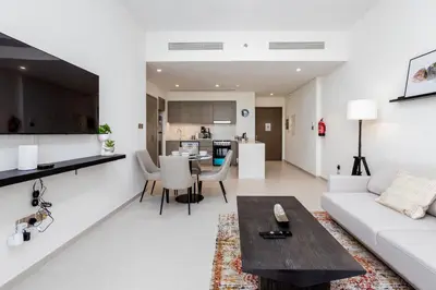 a living room with a couch and a table at Near Burj Khalifa - 1BR Apartment in Grande Residence, Downtown - Allsopp & Allsopp in Dubai
