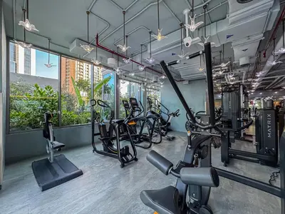 a gym with several treadmills and exercise bikes at Upmarket Studio in Business Bay with a Gym and Pool in Dubai