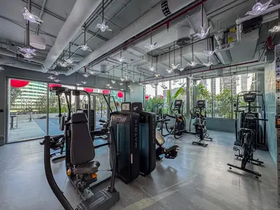 a gym with several treadmills and exercise bikes at Upmarket Studio in Business Bay with a Gym and Pool in Dubai