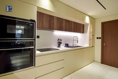 a kitchen with a microwave oven and a sink at Luxury Escapes - Three-Bedroom Apartment with Lake View in Dubai