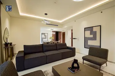 a living room with a couch and two chairs at Luxury Escapes - Three-Bedroom Apartment with Lake View in Dubai