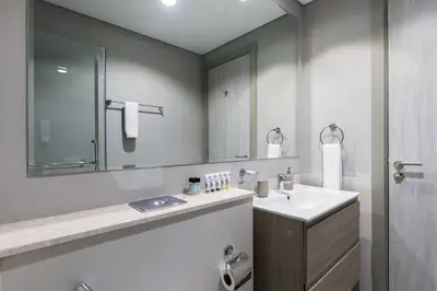 a bathroom with a sink and a mirror at Waves - Modern Apt with Balcony & Canal View in Business Bay in Dubai