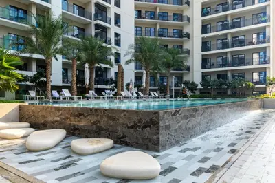 a swimming pool in front of a building at Waves - Modern Apt with Balcony & Canal View in Business Bay in Dubai