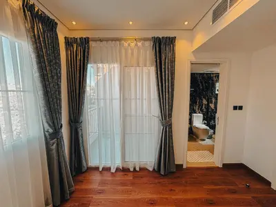 a room with a window with curtains and a toilet at The Springs 14-Charming 2-Bedroom Villa in By Al sarya Holiday Home in Dubai