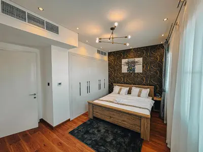 a bedroom with a large bed with a wall at The Springs 14-Charming 2-Bedroom Villa in By Al sarya Holiday Home in Dubai