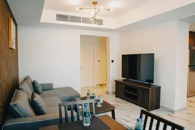 a living room with a couch and a flat screen tv at The Springs 14-Charming 2-Bedroom Villa in By Al sarya Holiday Home in Dubai