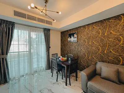 a living room with a table and a couch at The Springs 14-Charming 2-Bedroom Villa in By Al sarya Holiday Home in Dubai