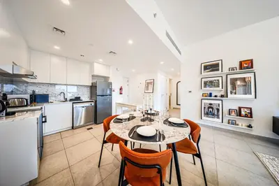 a kitchen and dining room with a table and chairs at New 1 BD in Madinat Jumeirah Living in Dubai