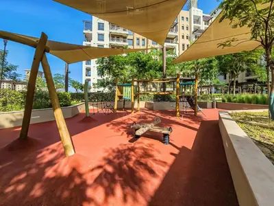 a playground with a drone on the ground under an umbrella at New 1 BD in Madinat Jumeirah Living in Dubai