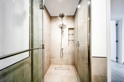 a shower in a bathroom with a glass door at New 1 BD in Madinat Jumeirah Living in Dubai