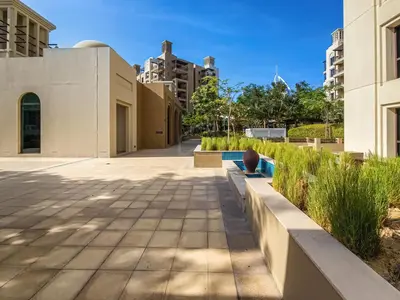 a walkway in a city with buildings at New 1 BD in Madinat Jumeirah Living in Dubai