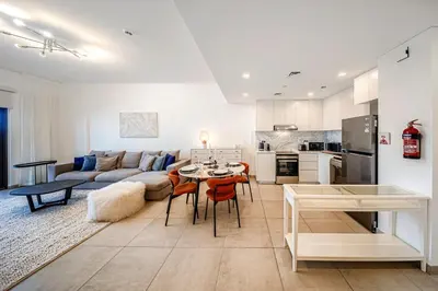 a living room with a couch and a table at New 1 BD in Madinat Jumeirah Living in Dubai