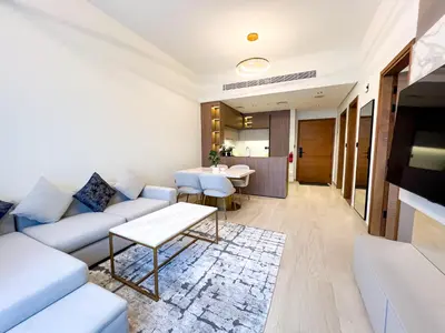 a living room with a couch and a table at Stylish 1-Bedroom Retreat in Prime Gardens , Arjan in Dubai