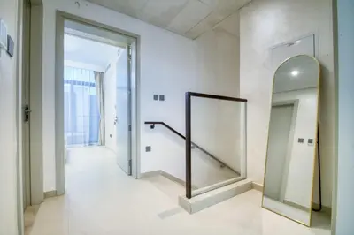 a hallway with a mirror and a staircase at Dubai dream villa Emaar in Dubai