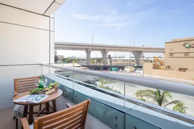 a balcony with a table and a view of a bridge at Frank Porter - Zen Tower in Dubai
