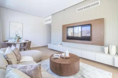 a living room with a tv on a wall at Frank Porter - Zen Tower in Dubai