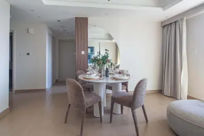 a dining room with a white table and chairs at Frank Porter - Zen Tower in Dubai