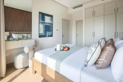 a bedroom with a large white bed with pillows at Frank Porter - Zen Tower in Dubai