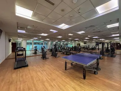 a gym with a ping pong table and exercise equipment at Frank Porter - Zen Tower in Dubai