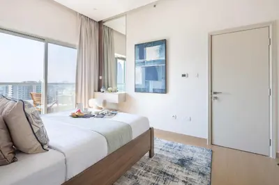 a bedroom with a bed and a large window at Frank Porter - Zen Tower in Dubai