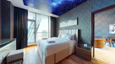 a bedroom with a large bed with a star ceiling at Stunning 2-Bed Apartment with Canal View in Dubai