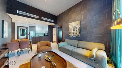 a living room with a couch and a table at Stunning 2-Bed Apartment with Canal View in Dubai