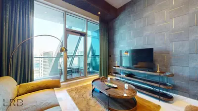 a living room with a couch and a table at Stunning 2-Bed Apartment with Canal View in Dubai