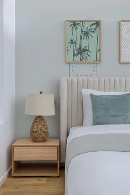 a bedroom with a bed and a table with a lamp at Frank Porter - Palm Views East in Dubai