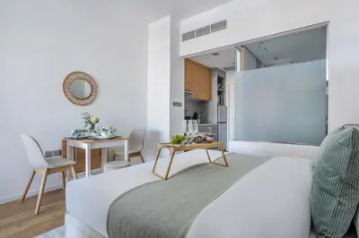 a bedroom with a bed and a table in a room at Frank Porter - Palm Views East in Dubai