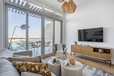 a living room with a couch and a tv at Frank Porter - Palm Views East in Dubai