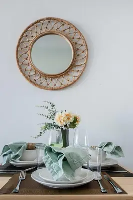 a dining room table with a mirror on the wall at Frank Porter - Palm Views East in Dubai