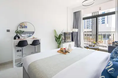 a bedroom with a bed with a teddy bear on it at Frank Porter - Legacy by Sunrise in Dubai