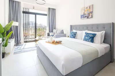 a bedroom with a large bed and a large window at Frank Porter - Legacy by Sunrise in Dubai