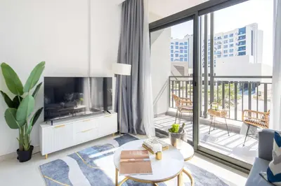 a living room with a tv and a large window at Frank Porter - Legacy by Sunrise in Dubai