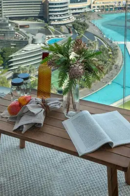 a wooden table with an open book and a book at Frank Porter - Grande Residence in Dubai