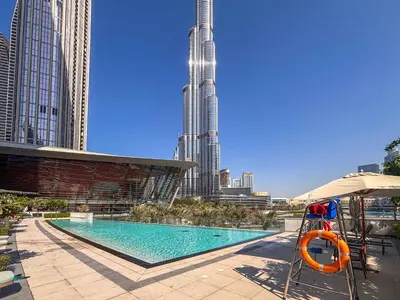 a swimming pool in the middle of a city with tall buildings at Frank Porter - Grande Residence in Dubai