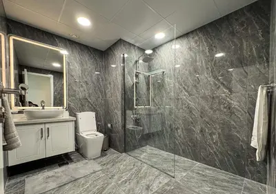 a bathroom with a shower and a toilet and a sink at DreamShoma-3BR Super Luxurious The Residence 5 Downtown in Dubai
