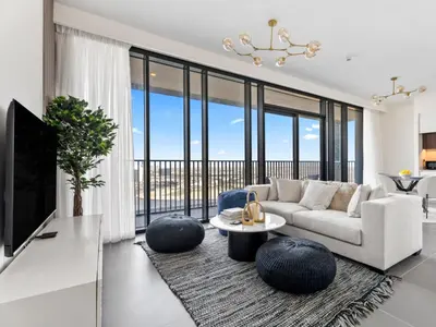 a living room with a couch and a table at Serene 2BDR with Beach Scenery In Creek Edge- Creek Harbour in Dubai
