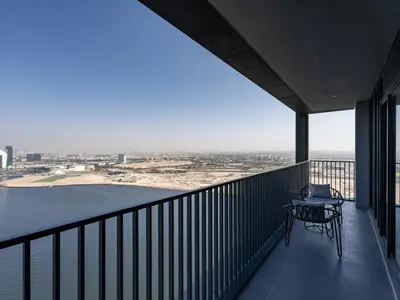 a balcony with a table and a view of the desert at Serene 2BDR with Beach Scenery In Creek Edge- Creek Harbour in Dubai
