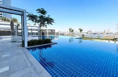 a large swimming pool on top of a building at Serene 2BDR with Beach Scenery In Creek Edge- Creek Harbour in Dubai